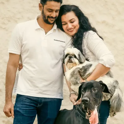 A beautiful family portrait where a gentle Great Dane and a spunky Shih Tzu complete the picture. This is a perfect example of a 'big meets small' story, capturing the love that makes a house a home.