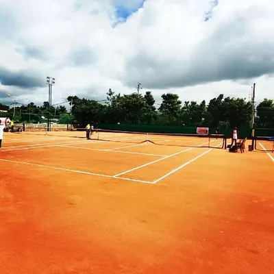 A pristine view of one of our clay courts, freshly marked and ready for play.