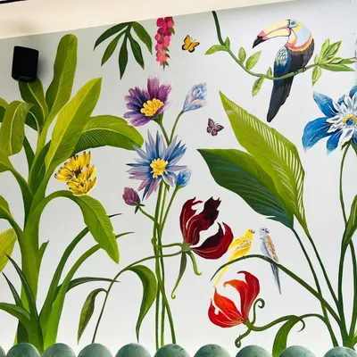 A close-up of the tropical mural, showing the detail on the toucan and the variety of flowers. Each element was hand-painted to create a lush, immersive jungle feel for a child's bedroom.