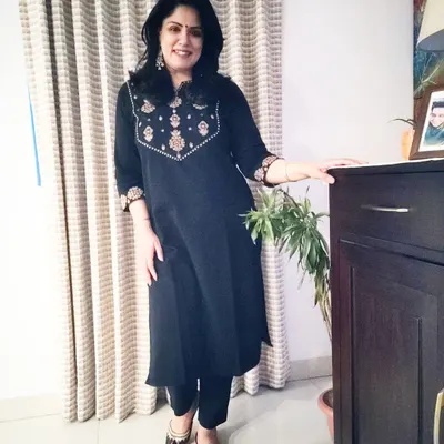 A full-length view of my comfortable black kurta set, paired with traditional juttis. It's a go-to outfit that is both elegant and easy to wear.