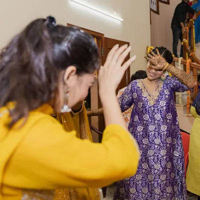 A candid moment from a Mehendi function. The bride, a Telugu woman from Vishakhapatnam, chose to wear a vibrant purple Banarasi kurta with bandhani pants, a beautiful fusion of cultures that we curated virtually.