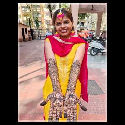 My beautiful bride Darshana, glowing with happiness on her mehendi day. Her custom design tells her unique story.