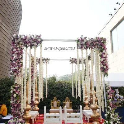 A beautiful day wedding mandap at The Westin, featuring lush purple and white floral arrangements with hanging jasmine garlands. The design combines traditional elements with a fresh, modern aesthetic for an elegant outdoor ceremony.