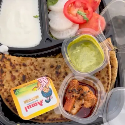 My signature Gobhi Paratha Meal, a customer favorite. This complete meal includes a perfectly cooked stuffed paratha with dahi, butter, pickle, chutney, and a fresh salad.