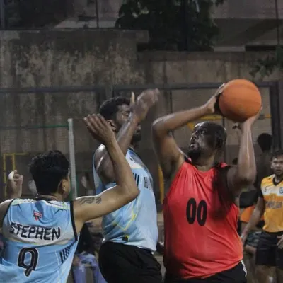 A player goes up for a tough shot in the paint, surrounded by defenders. This is the grit and determination we see in every game.