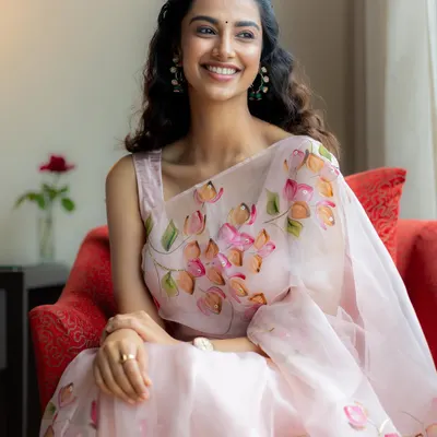 A full view of the hand-painted Picchika saree. The delicate organza fabric and soft floral pattern create a look of pure elegance and grace.