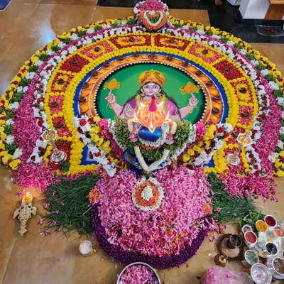 A magnificent Durga Deepa Namaskara pooja setup. The goddess is invoked through the mandala and worshipped with hundreds of lamps and flowers.