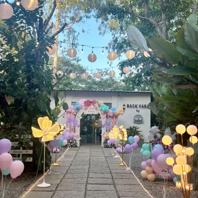 This is how I create a magical journey for your guests. The entrance to this outdoor party was a long, beautifully lit path with glowing flowers and lanterns, leading to the main celebration area.