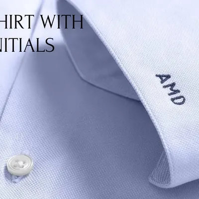 We offer personalization options like monogramming to make your bespoke shirt truly your own. This close-up shows initials stitched onto the cuff of a custom-made shirt, a small detail that adds a touch of personal luxury.