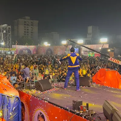 Facing a sea of thousands at a Navratri event. This is my view from the stage, and it's a feeling that never gets old. My job is to make sure every single person in that crowd feels the energy.
