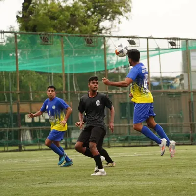 A player rises high to win an aerial duel during our quarter-final match, showing the physical commitment required.
