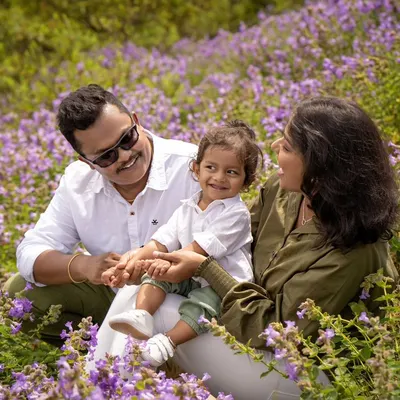A family enjoying a day out in a field of beautiful Neelakurinji flowers. This once-in-12-years bloom provided a stunning and unique backdrop for this first-year milestone shoot.