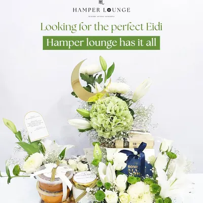 This stunning Eid hamper is designed to impress, featuring a large floral arrangement of white lilies and green hydrangeas. The crescent moon accent adds a festive touch, while the base contains jars of gourmet treats, making it a perfect centerpiece gift for clients.