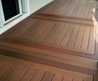 A close-up of a masterfully crafted wooden deck. The design features intricate inlay patterns, showcasing our attention to detail and high level of carpentry skill.