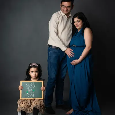A proud big sister. We love this family portrait where the older sibling holds a "Big Sister" sign, officially announcing her new role.