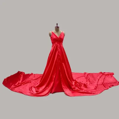 A full view of our popular red satin gown, displaying the expansive trail that brings a 'wow' factor to any maternity photoshoot. This dress is available for rent in both RR Nagar, Bengaluru and Chitradurga.