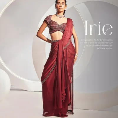 The Irie Saree Set in a rich wine color. This pre-draped concept saree is paired with a fully embellished sweetheart blouse, offering a sophisticated look for any celebration.