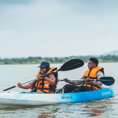 A couple enjoying a tandem kayak adventure on the lake. Paddling together is a great way to have fun and work as a team.