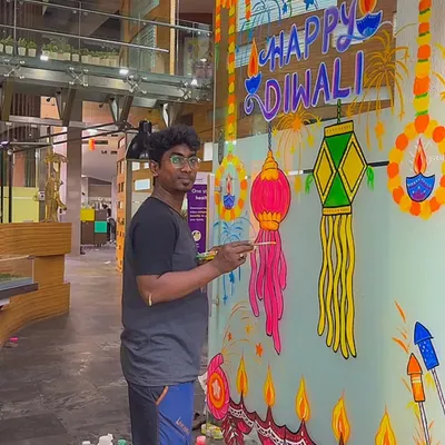 Here I am, live in action, creating a large-scale Diwali mural on a glass partition for an office space in Navi Mumbai. I bring all my own materials and paint directly on the surface, turning any plain window into a festive masterpiece.