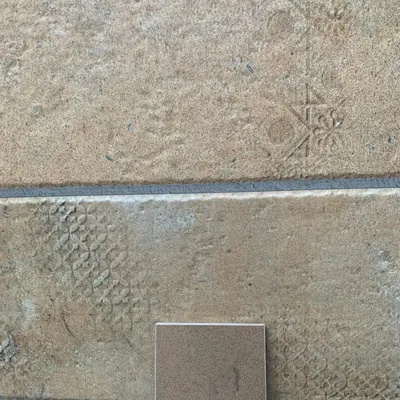 We are constantly experimenting with natural materials. This image shows a test panel of lime plaster with subtle patterns impressed upon its surface, a technique we use to add texture and a handmade quality to our walls.