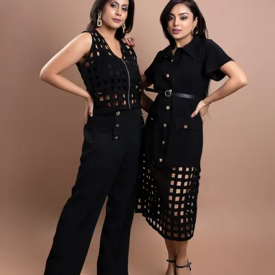 For this brand campaign, we captured two models together to highlight the versatility of the collection. Posing them against a neutral backdrop ensures the focus remains on the sharp tailoring and coordinated black ensembles, perfect for a modern fashion lookbook.