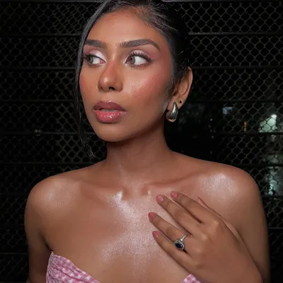 A beautiful profile shot of this pretty-in-pink look. The focus is on dewy, glowing skin and soft pink tones on the eyes, cheeks, and lips.