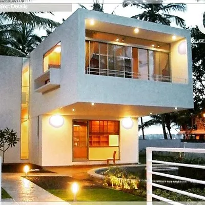 A contemporary villa in HSR Layout where the landscape design is clean and intentional. The strategic lighting and simple garden layout complement the modern architecture, creating a spacious and welcoming atmosphere.