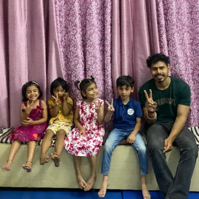 A therapist with a group of smiling children. These happy faces are the reason we do what we do, and we cherish the strong bonds we build.