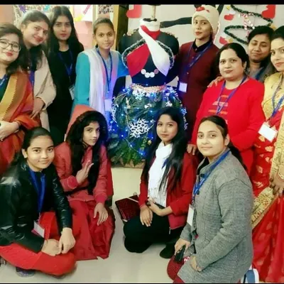 Our students and faculty celebrating together at the institute. This group photo captures the happy and collaborative environment we foster, with everyone gathered around a creative mannequin display made for a festive occasion.