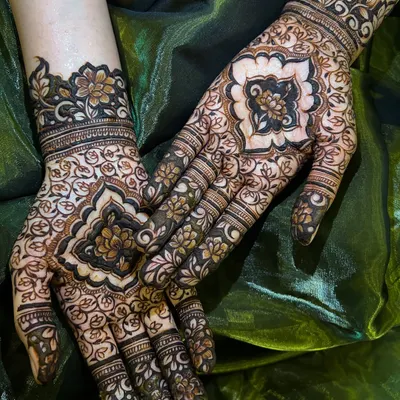 A beautiful flat-lay of a completed design, showcasing the intricate patterns on the palms and the delicate work on the fingers.