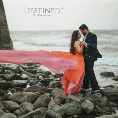A beautiful shot on a rocky Goa beach, with the bride's flowing gown catching the wind as the couple shares a dance, perfectly capturing a "destined for each other" moment.