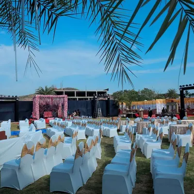 A wide view of an outdoor wedding setup at a destination resort. We arranged the guest seating to provide a clear view of the main stage, ensuring everyone feels part of the ceremony.