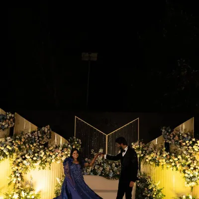 Every love story is a fairytale, and we planned Raksha and Ram's reception to feel just like one. Here they are, having their first dance on a stage filled with flowers, creating a truly magical moment.