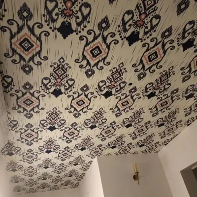 An example of a ceiling wallpaper installation. This traditional ikat pattern adds an unexpected and stylish element to the room.