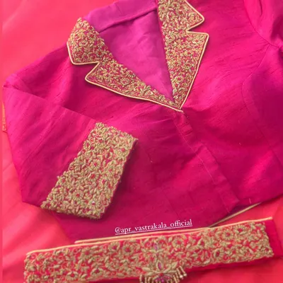 A modern take on the traditional blouse. This pink blouse features a notched collar design, with the lapels heavily embroidered in gold zardosi for a fusion look.