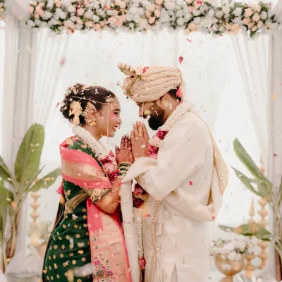 A moment of reverence and mutual respect as the couple greets each other with a 'namaste' during their Maharashtrian wedding ceremony.