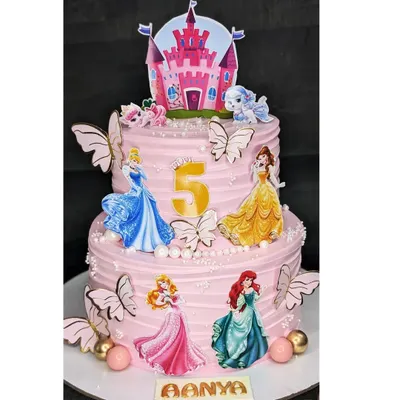A two-tier Disney Princess dream cake for a 5th birthday. This eggless black forest cake is decorated with multiple princesses, butterflies, and a castle topper for a truly royal celebration.