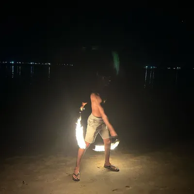 Spinning fire poi on a dark beach is an intense experience. The sound and heat of the flames add a powerful element to the flow. Safety is always the first priority when we get to this level.