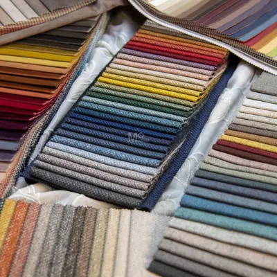 Dive into a world of textures and hues with our upholstery fabric collection. This image displays a rainbow of options, from rich reds and deep blues to earthy greens and yellows.