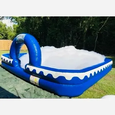 This is our large inflatable foam pit, filled to the brim with fluffy, safe foam. It provides a contained and super fun area for kids to enjoy a foam party without making a mess of the whole yard.