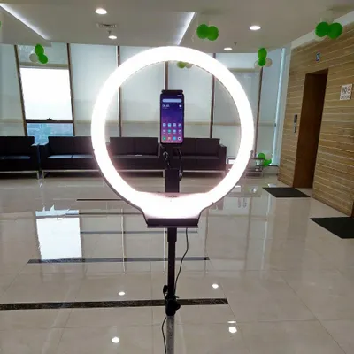 A look at one of our simple yet effective setups, featuring a large ring light with a smartphone mount. This configuration ensures perfect, even lighting for boomerang videos and digital photos, making everyone look their best.