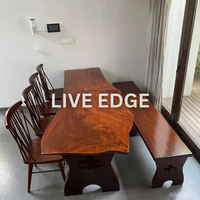 Our signature live-edge dining table, crafted from a single slab of wood to preserve its natural shape. Paired with classic spindle-back chairs and a matching bench, it creates a warm, organic dining experience.