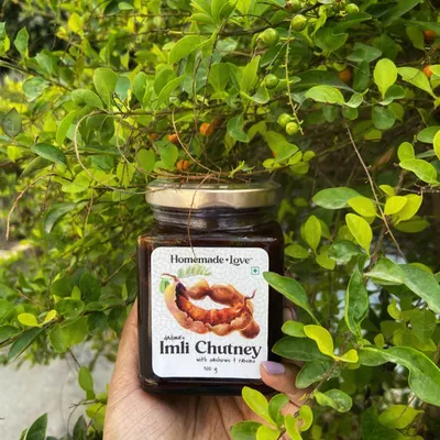 Here is my dadima's Imli Chutney, held against a backdrop of fresh greenery. It's a reminder that I only use natural ingredients to create that unforgettable sweet and tangy flavour.