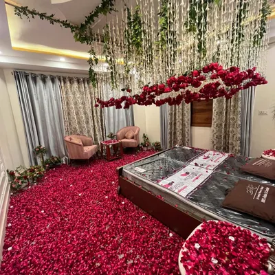 A wide view of a room transformed with a ceiling floral installation. I used hanging green vines and floral strings to create a magical canopy effect over the entire space.