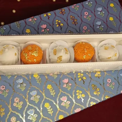 A perfect festive combination, this gift set features two laddoo candles and three modak candles. Packed in a beautiful floral box, it's a unique and sweet gift for Diwali or any celebration.