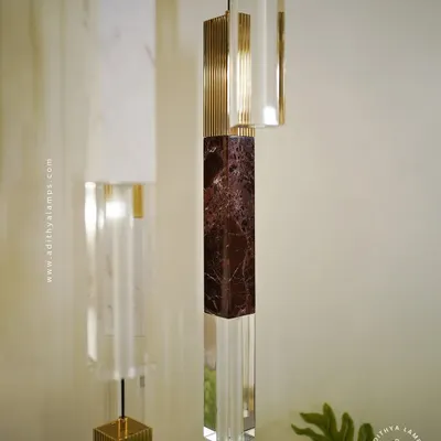 A collection of our pillar pendants, which combine sections of solid marble, fluted metal, and clear crystal. These substantial, high-quality fixtures can be hung individually or in clusters to create a dramatic effect in stairwells or entryways.