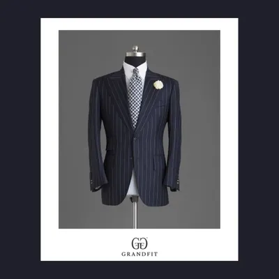 A classic navy pinstripe suit jacket, defined by its sharp tailoring and accessorized with a lapel flower for a touch of celebratory flair.