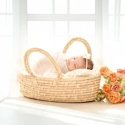 A simple and beautiful portrait of a newborn in a basket, backlit by a bright window. This classic, high-key lighting creates a soft and angelic feel.