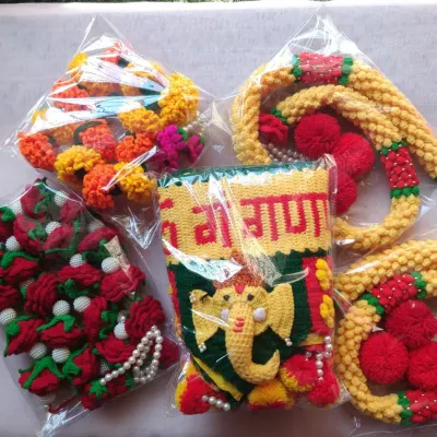 A dispatch photo showing a Ganpati Toran, Mogra latkan, Rose garland, and Marigold garland, all packed and ready to be sent to a customer.