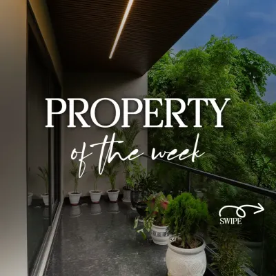 This is our property of the week, featuring a beautiful balcony with lush greenery. The space is designed as a peaceful escape, with dark flooring and a wood-paneled ceiling.